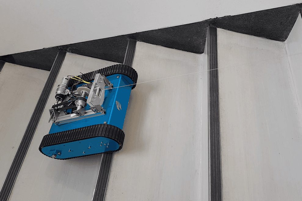 The tracked robot climbing a staircase on its tether
