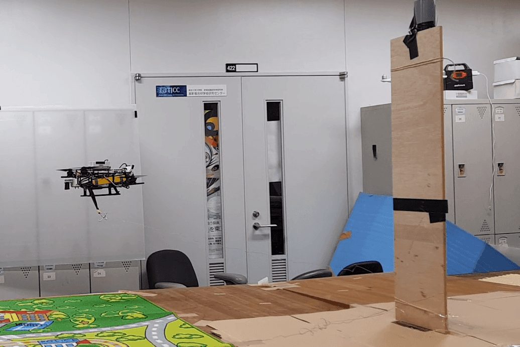 The drone flying next to a wooden pole on top of the test slope